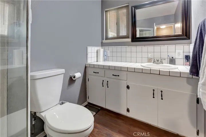 Bathroom located on side of home with just one bedroom. upgraded flooring, Large sink counter top and new Toilet.  Designer mirrow along with newer faucet.