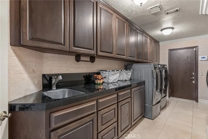 Individual Laundry  room with a 2nd refrigerator downstairs.