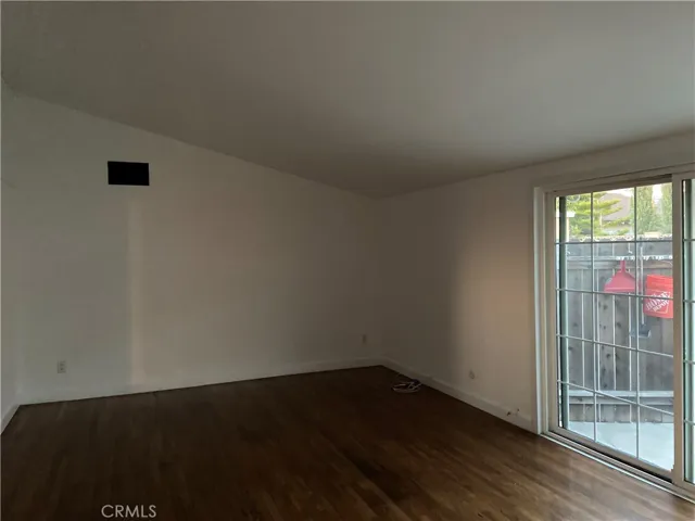 Living Room Vaulted Ceiling, Hardwood Flooring, Dual Pane Sliding Door