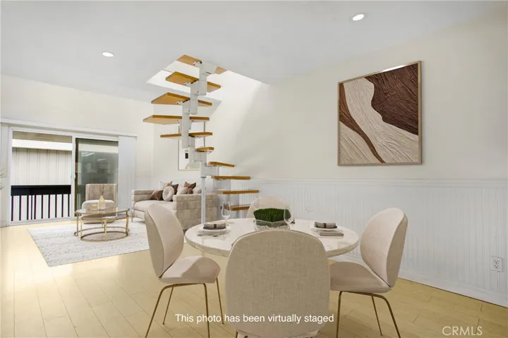View from dining towards large balcony at end of living room.
