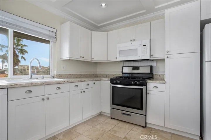 Kitchen with large window and tall pantry with pull outs
