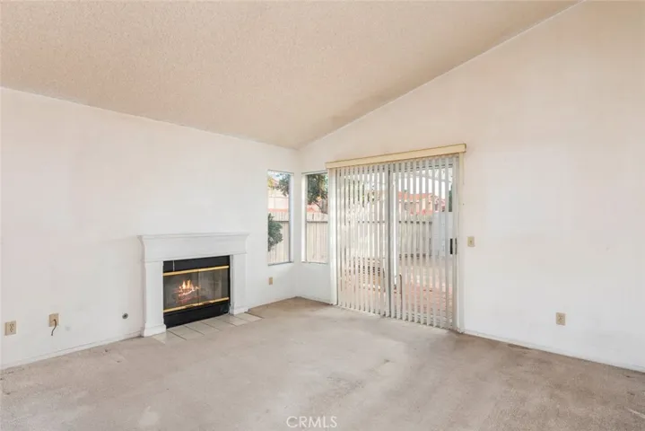 Expansive living space featuring a cozy fireplace