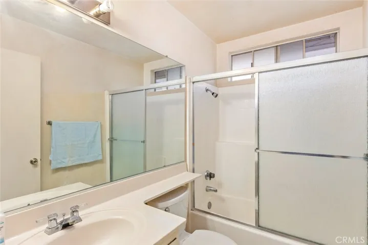 A comfortably sized bathroom with a combined tub and shower