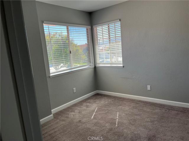 Upstairs bedroom with tree and street view