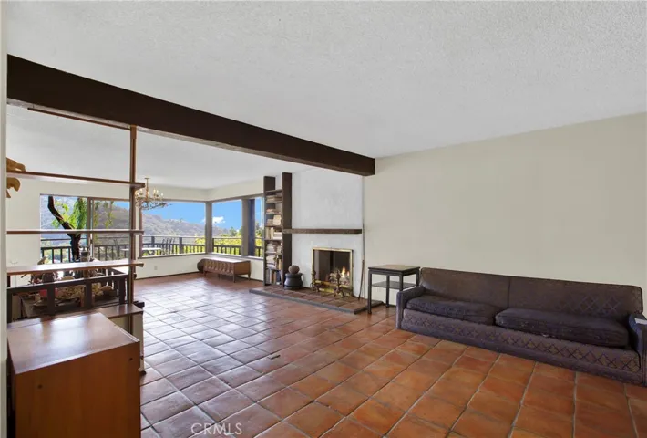 Living room view towards fireplace and dining room with sit down ocean view.
