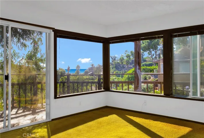 Primary bedroom with multiple windows and ocean views.