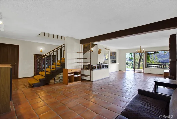 Living room with open beamed ceilings and looking towards rear ocean view deck.