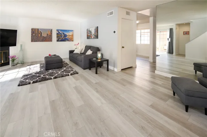 Open floor plan. Kitchen is behind Mirrored wall.