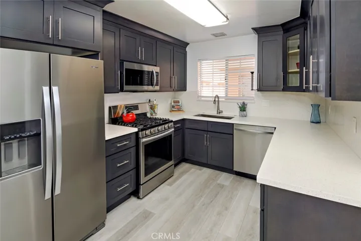 Remodeled Kitchen with stainless steel appliances and quartz countertop. The refrigerator has a waterline and ice maker.