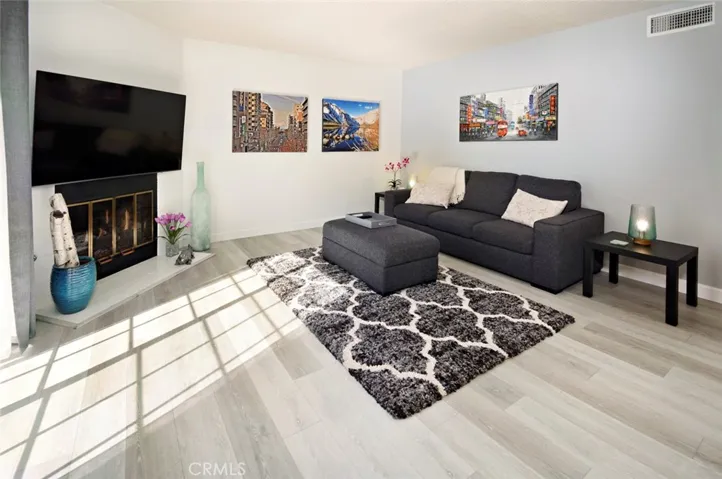 Living room with gas fireplace and luxury vinyl flooring.