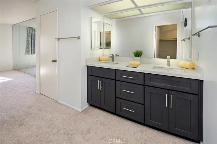 Primary suite has 2 closets and updated dual vanity sinks.