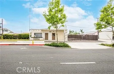 Front exterior view of the property's main entrance and gated parking lot.