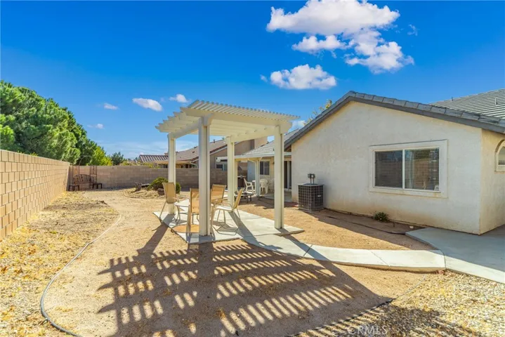 Another view of back yard with pergola