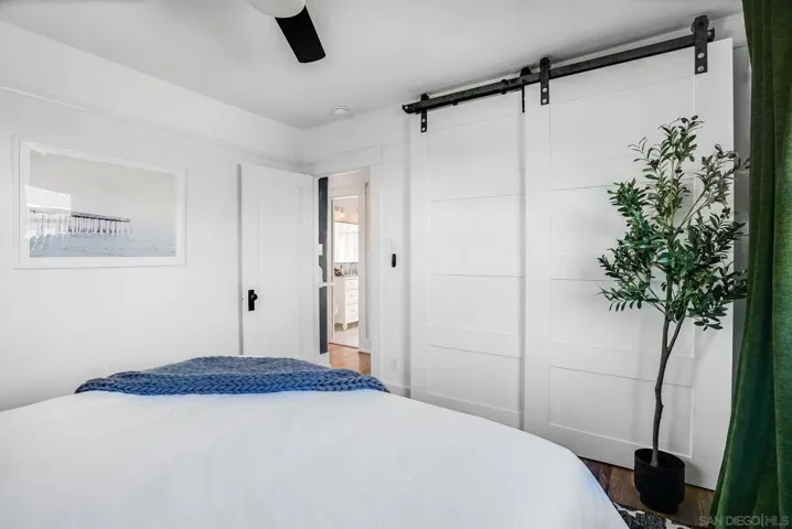 Light & bright primary bedroom with King-sized bed and closet with beautiful barn doors.