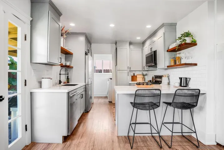 Fully remodeled kitchen with stainless steel appliances, built-in pantry and 5 burner gas stove! VERY unique for a bungalow like this.
