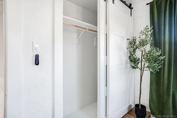 Light & bright primary bedroom with King-sized bed and closet with beautiful barn doors.