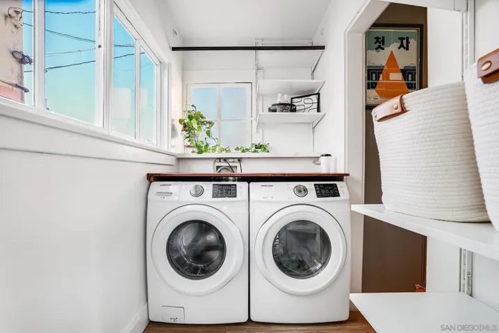 Indoor laundry room with plenty of storage. Washer & dryer convey with the sale!