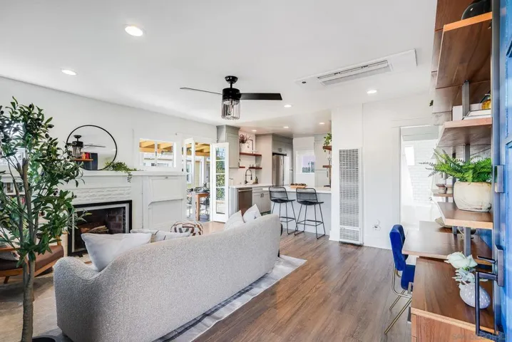 Entryway overlooking living room, kitchen, and French doors leading to outdoor dining on beautiful Trex deck.