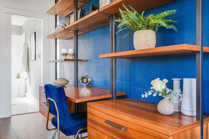 Beautiful wooden desk with shelving flanked by two bookshelves - these are staying with the home!