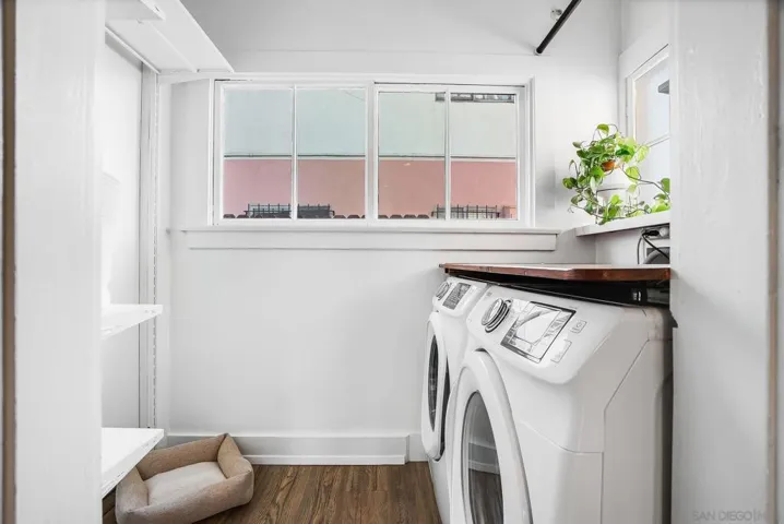 Indoor laundry room with plenty of storage. Washer & dryer convey with the sale!