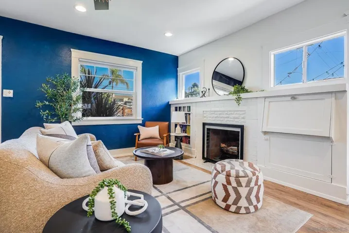 Open living room with some 1924 charm and a fully functional wood-burning fireplace