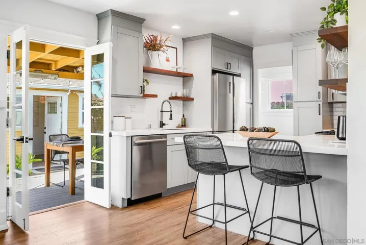 Indoor-outdoor living! Large open kitchen with French doors leading to outdoor dining on oversized Trex deck