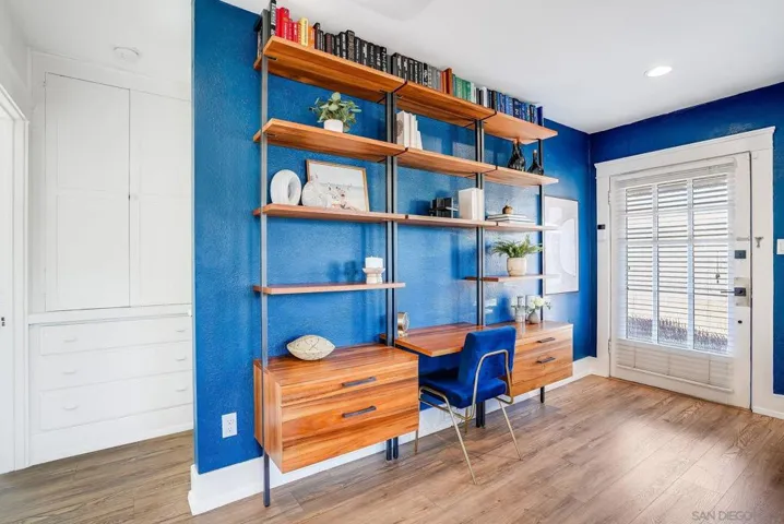 Beautiful wooden desk with shelving flanked by two bookshelves - these are staying with the home!