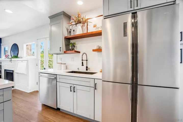 Fully remodeled kitchen with eat-in bar top, stainless steel appliances, built-in pantry and 5 burner gas stove! VERY unique for a bungalow like this.