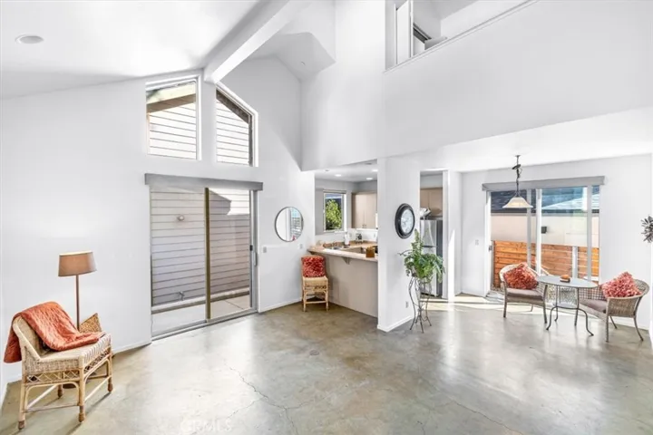 Living area with vaulted ceilings, concrete floors, fantastic natural light and open concept living
