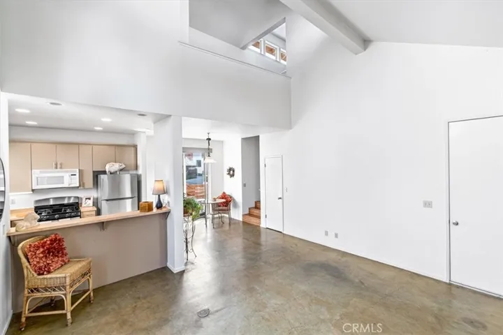 Living room, dining room, and kitchen with breakfast bar