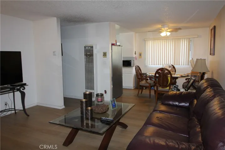 A living room, dining area in a two bedroom unit.