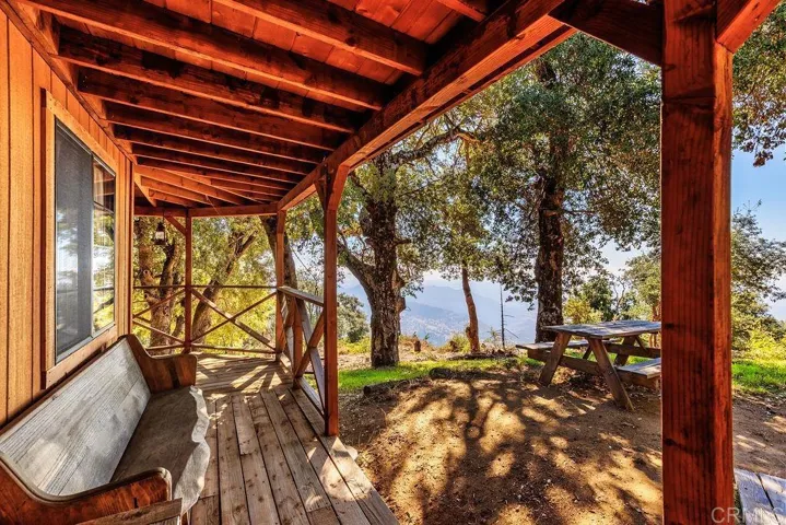 You'll love the wrap-around deck with views to the ocean from under a canopy of oaks.