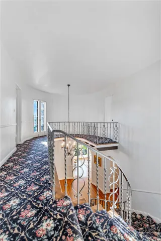 Top of grand staircase. Primary down on left, bedroom 2 loop around right and bedroom 3 behind on right.