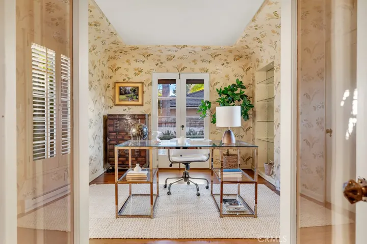Office from entry. Hallway with closet on left and powder room on right.