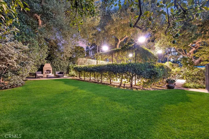 Yard behind pool and near fireplace.