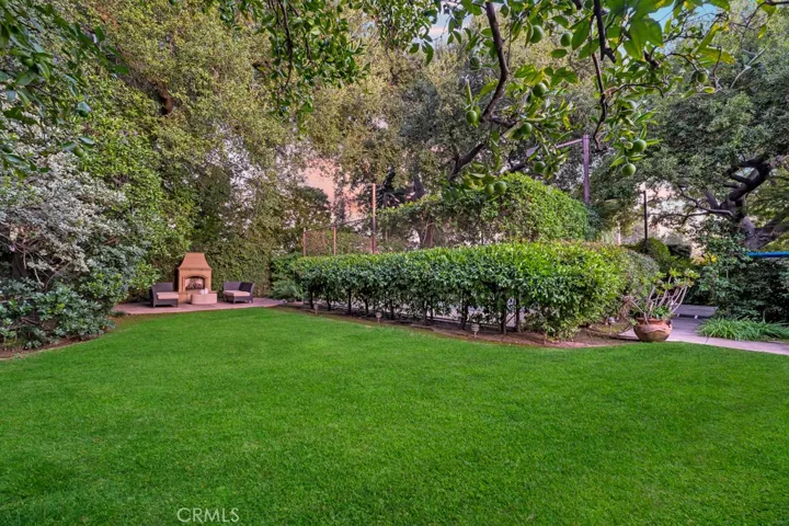 Yard behind pool and near fireplace.