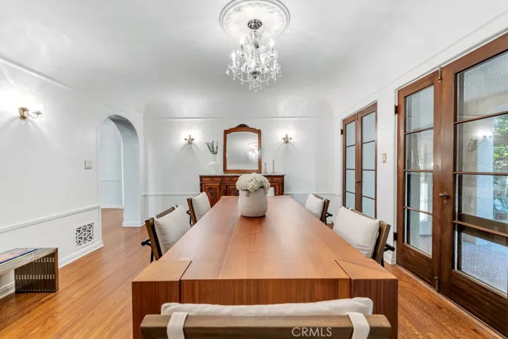 Formal dining room from back wall. Fench doors to outdoor patio and then fountain.