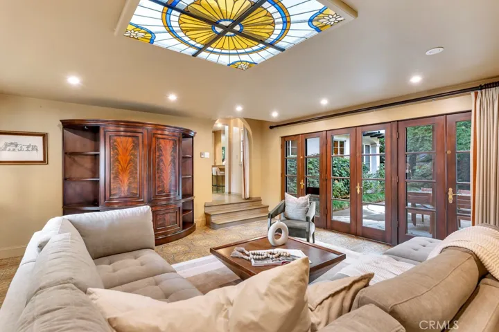 Family room from back corner. French doors open to pool and patio.