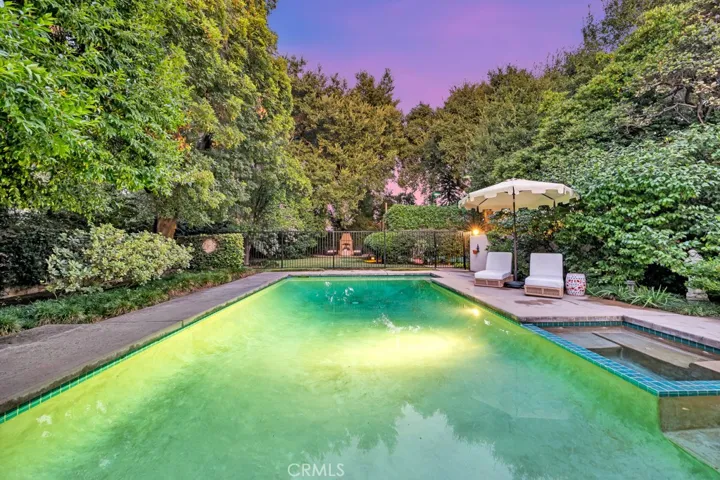 Pool, hot tub and view to backyard.