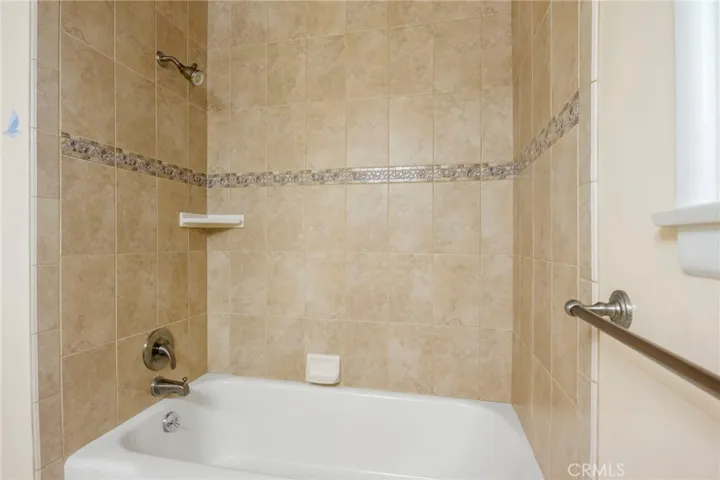 A tub shower unit in the hall bath