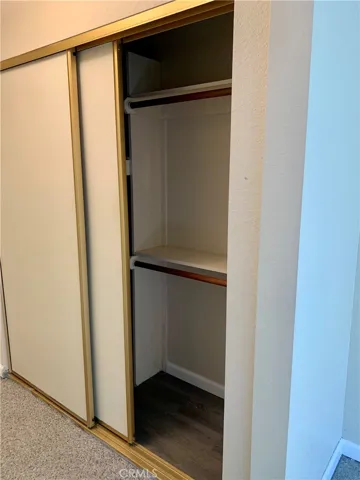 Dual closets both with built in cabinets and multiple rods.