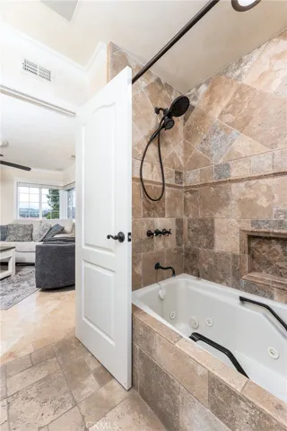 Jetted tub with exquisite stone work surround in second full bathroom