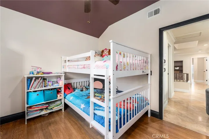 Bedroom two with vaulted ceilings and large closet with organizers.