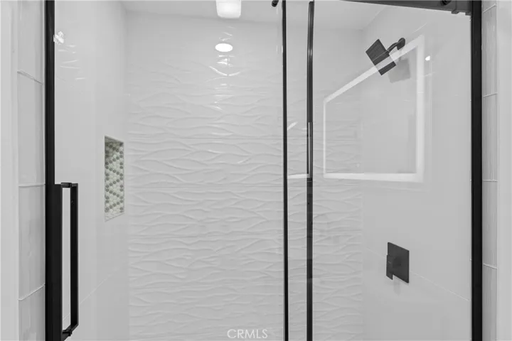 Custom bath w/ wave tile from floor to ceiling