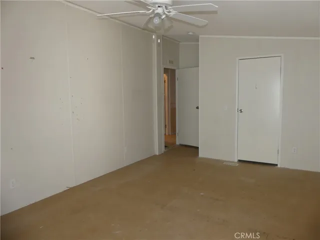 Primary Bedroom with Ceiling Fan and Walk-in Closet