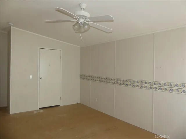Primary Bedroom with Ceiling Fan and Walk-in Closet