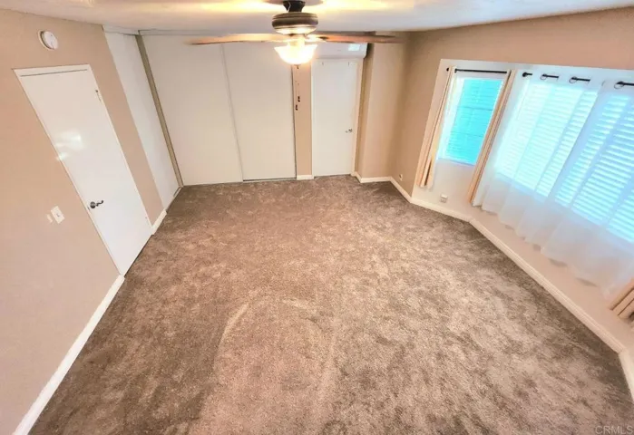Spacious and airy main bedroom offers double closets and full bathroom and fresh new carpet.