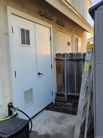 Additional storage space in backyard has new double doors.