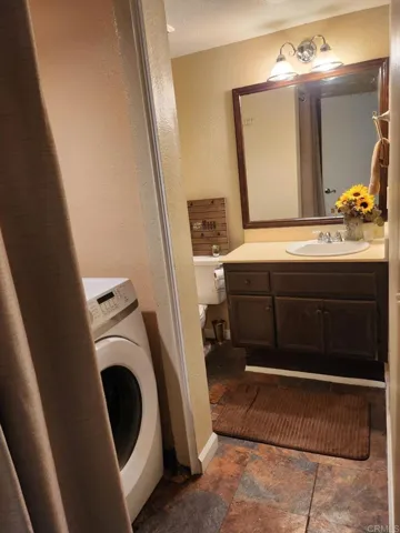 Convenient downstairs half bathroom and washer/dryer closet area.