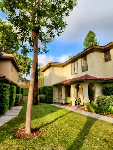Main Entry, surrounded by beautiful mature trees.